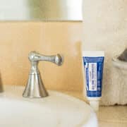 Travel-size toothpaste next to a bathroom sink