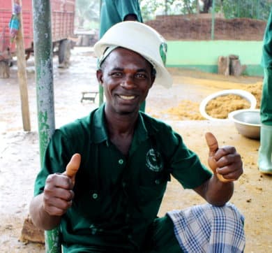 A man posing for a photo with his thumbs up
