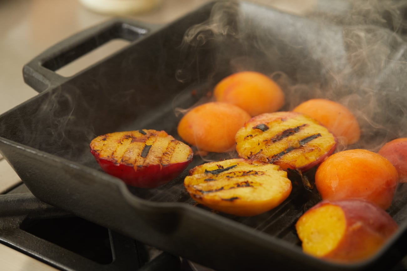 Grill pit fruit on a cast-iron grill