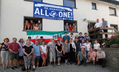 Members of the Bronner family standing in front of a building